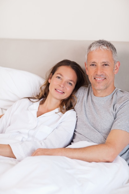 Portrait of a couple lying on a bed