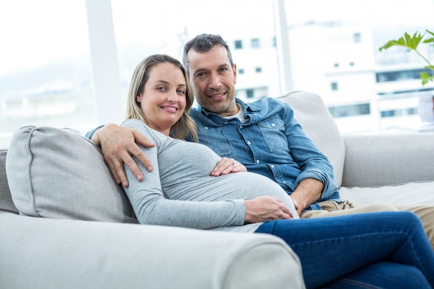 Portrait of couple sitting on sofa