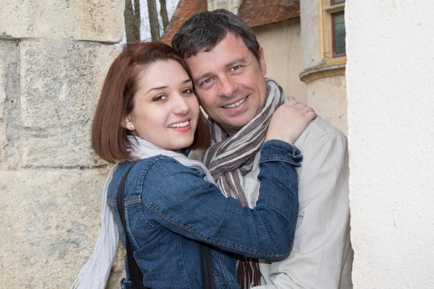 Portrait of a couple on vacation hugging on a sunny day