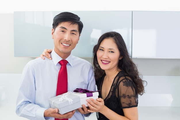 Portrait of a couple with a gift box in kitchen