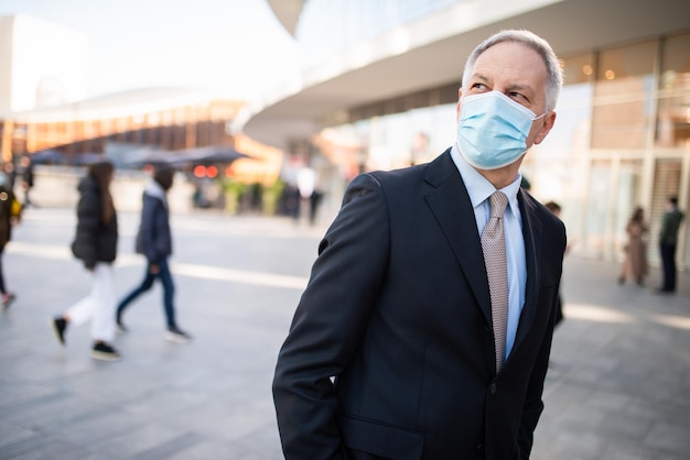 Portrait of a covid coronavirus masked businessman