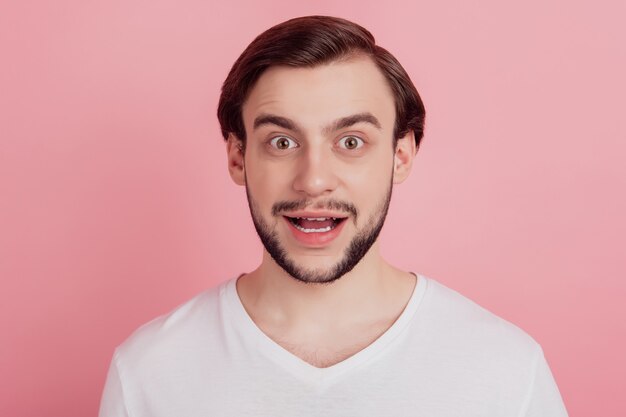 Photo portrait of crazy excited amazed guy open mouth on pink background