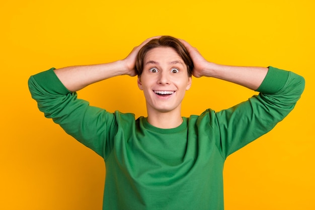 Portrait of crazy excited guy hands head open mouth unexpected novelty isolated bright color background