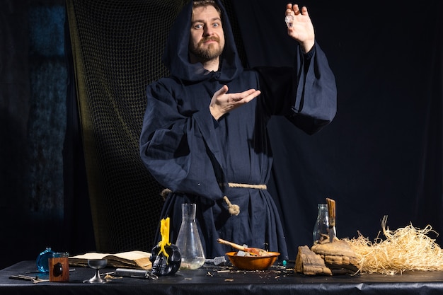 Portrait of a crazy medieval scientist working in his laboratory.