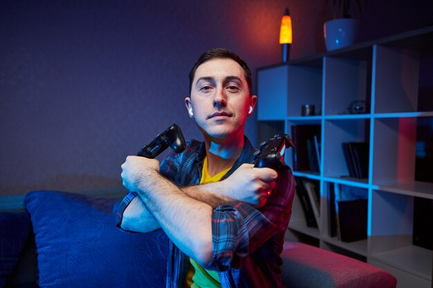 Photo portrait of crazy playful gamer enjoying playing video games