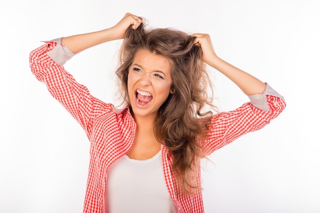 Photo portrait of crazy woman shouting and holding hair