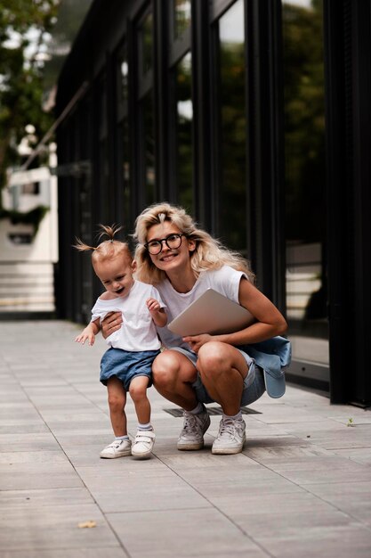 Portrait of a creative young smiling woman with a child in sunglasses. beautiful girl .