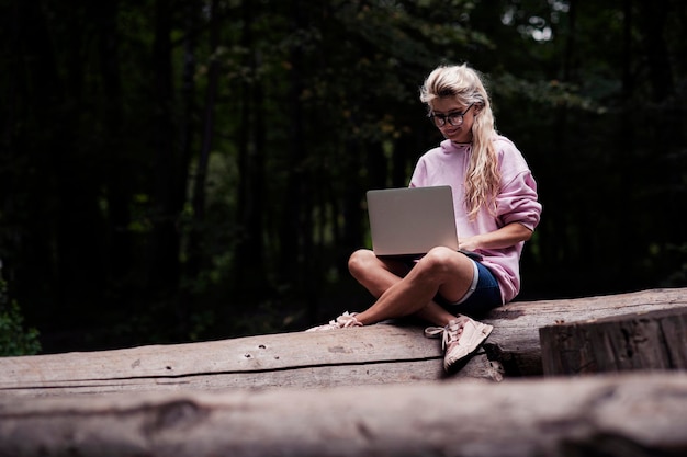 Photo portrait of a creative young smiling woman. work on laptop, lovely girl.