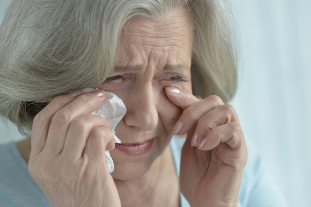 Portrait of a crying senior woman close-up