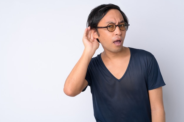 Portrait of curious Japanese man thinking while listening