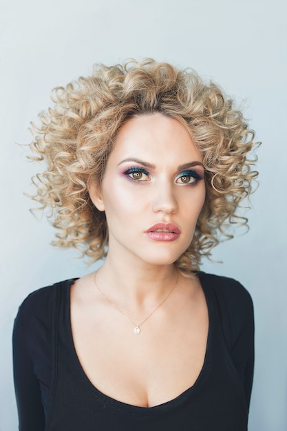 portrait of a curly woman with beauty makeup