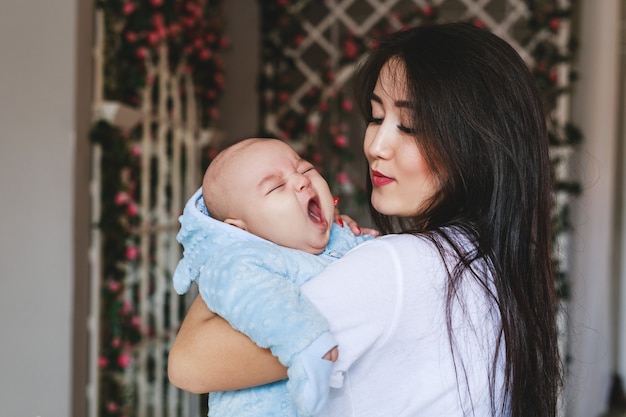 Portrait of a cute asian baby boy yawning.