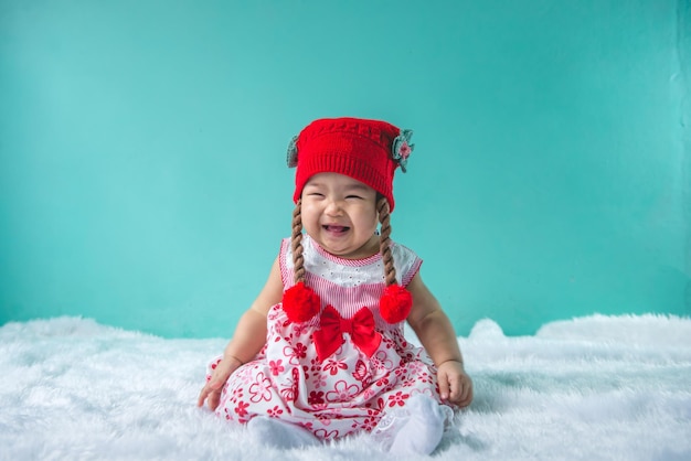 Portrait of cute asian baby in pink dress on carpet woolhappy baby conceptsmilethail little baby