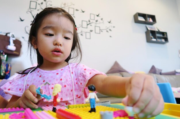 Portrait of cute asian girl playing lego