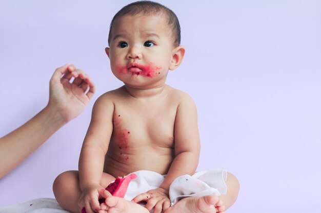 Portrait of cute baby boy against white background