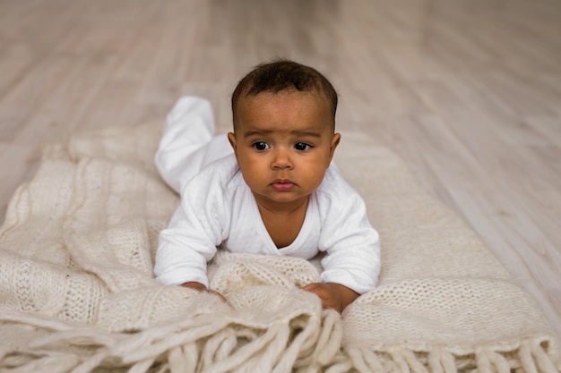 Portrait of cute baby boy on bed