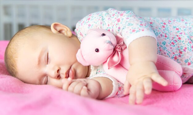 Photo portrait of cute baby boy lying on bed at home