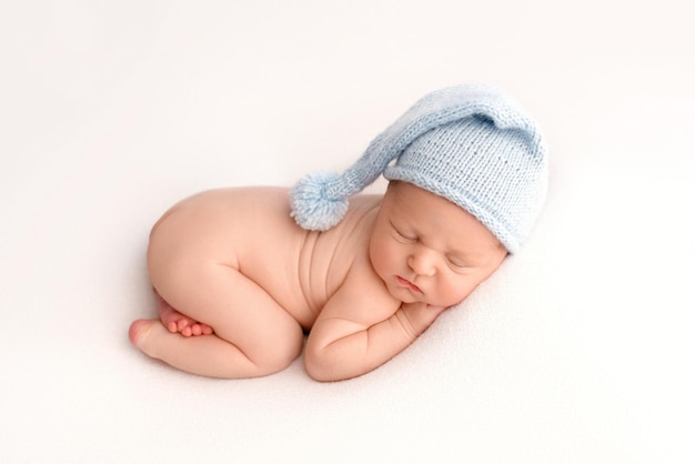 portrait of cute baby boy lying on white background