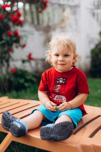 Photo portrait of cute baby boy sitting at park