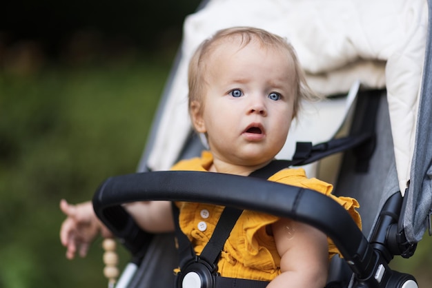 portrait of cute baby boy sitting in park