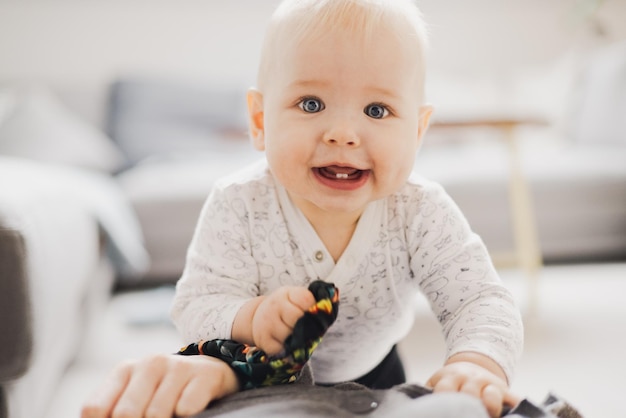 portrait of cute baby boy sitting on sofa at home