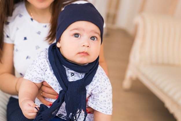 Portrait of cute baby boy wearing blue hat.