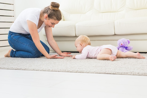 Portrait of a cute baby crawling and laughing on the floor at home