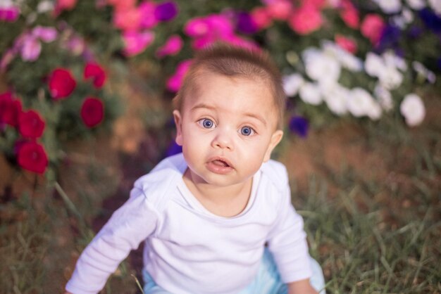 Portrait of cute baby girl on field