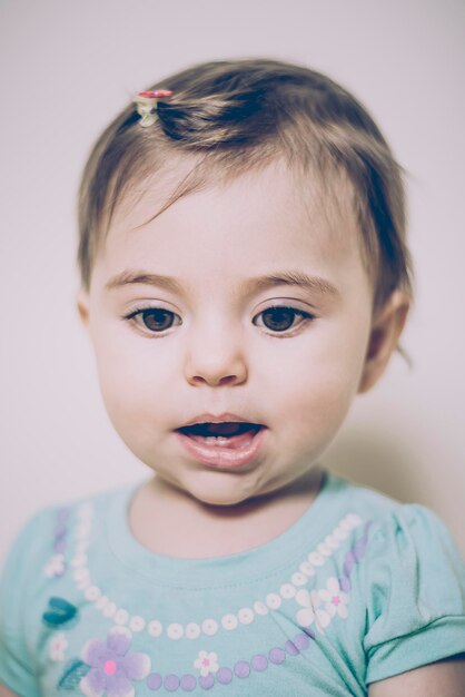 Photo portrait of cute baby girl at home