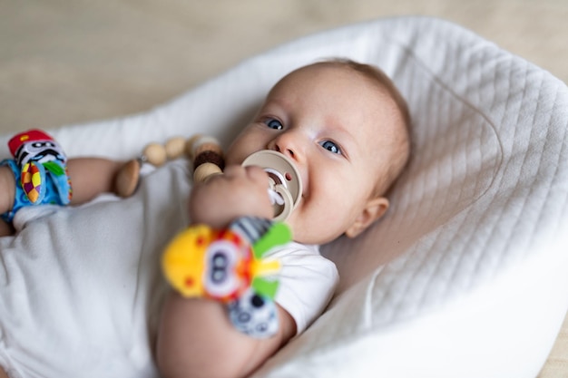 Photo portrait of cute baby girl lying on bed at home