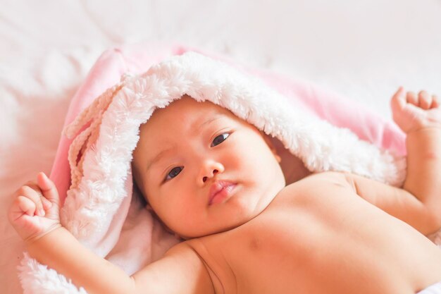 Portrait of cute baby girl lying on sofa