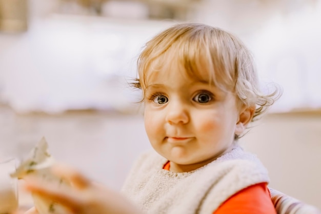 portrait of cute baby girl sitting at home