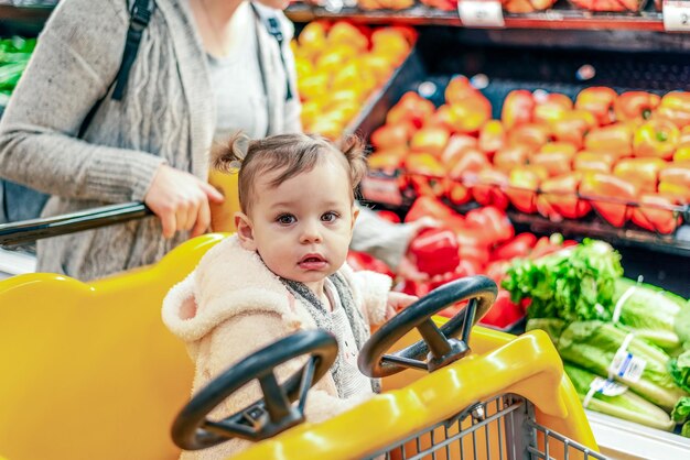 Photo portrait of cute baby girl in store