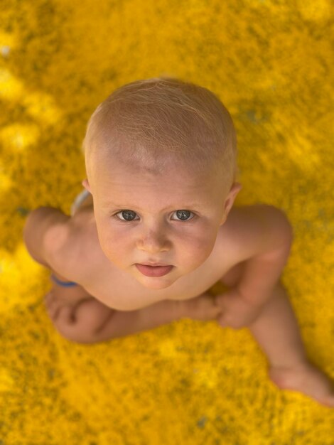 Portrait of cute baby girl with yellow flower