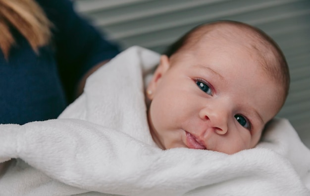 Photo portrait of cute baby girl wrapped in towel