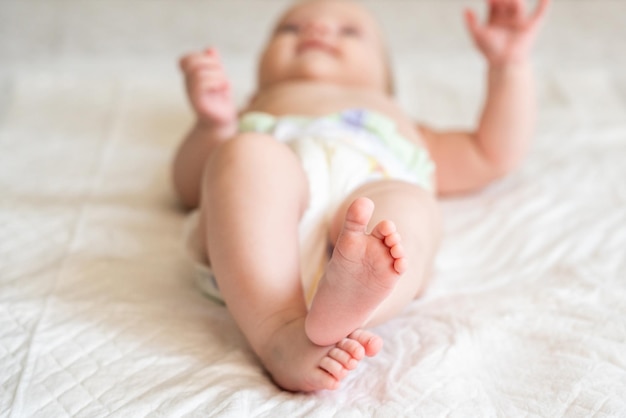Photo portrait of cute baby lying on bed at home