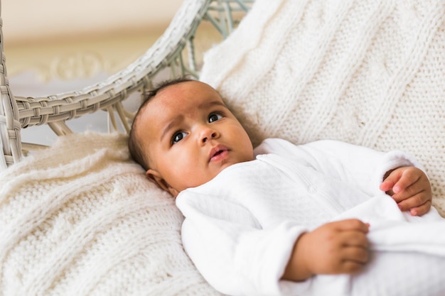 Portrait of cute baby lying on bed