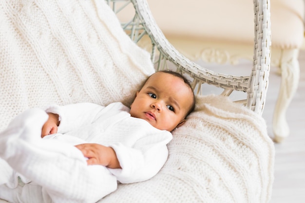 Portrait of cute baby lying on bed