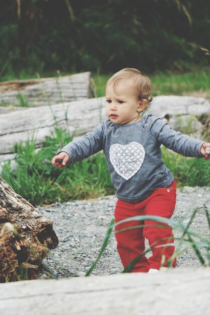 Photo portrait of cute baby running on beach