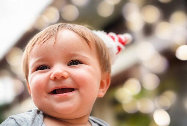 Photo portrait of the cute baby in santa hat christmas