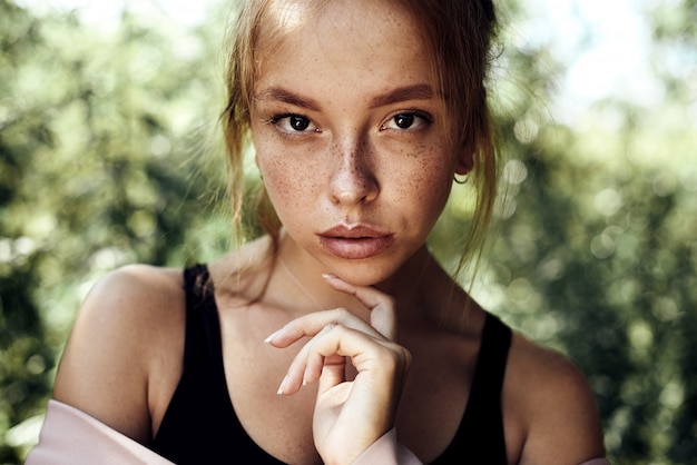 Portrait of cute beautiful young girl with freckles close-up