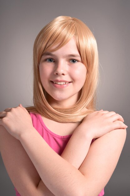 Portrait of cute blonde girl posing in studio