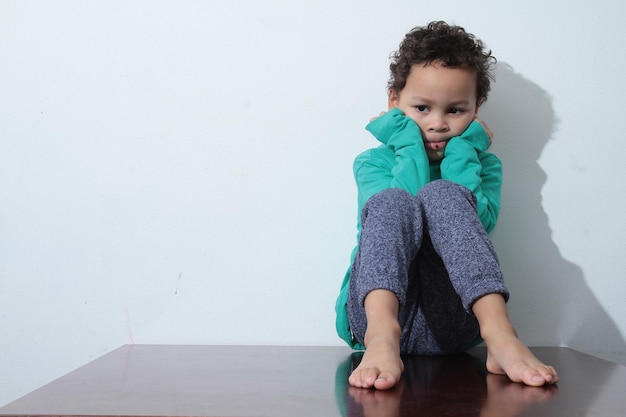 Photo portrait of cute boy against wall at home stock photo