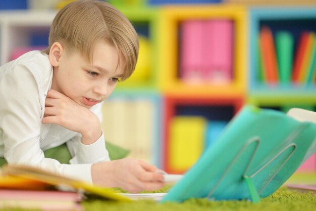 Portrait of a cute boy doing homework