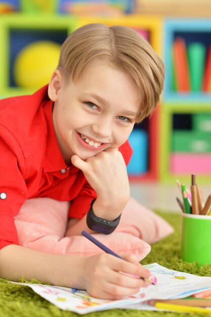 Portrait of a cute boy drawing with pencils