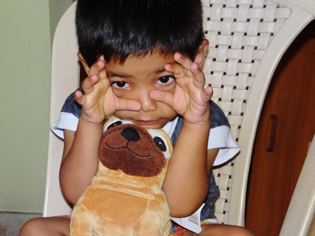 Photo portrait of cute boy holding camera