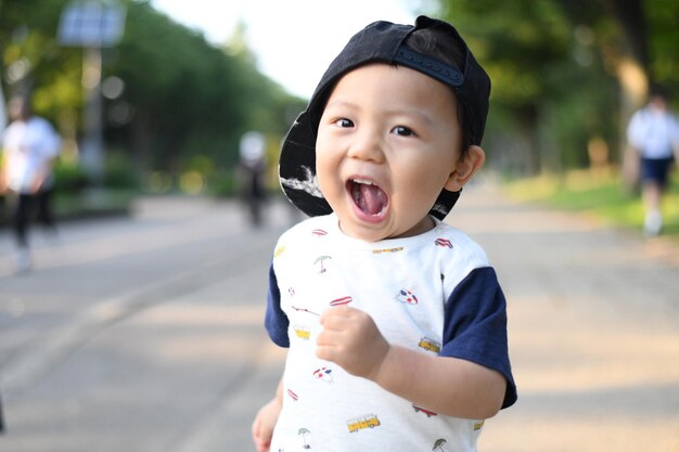 Portrait of cute boy running on street