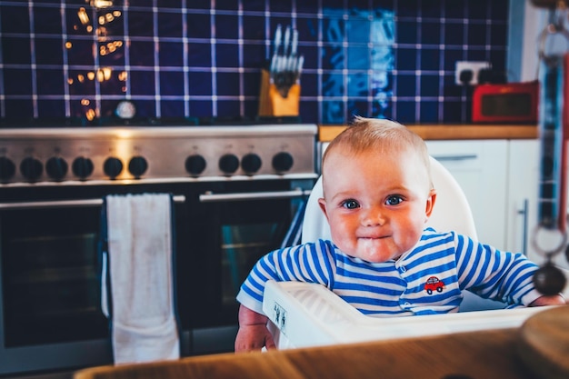 Photo portrait of cute boy sitting at home