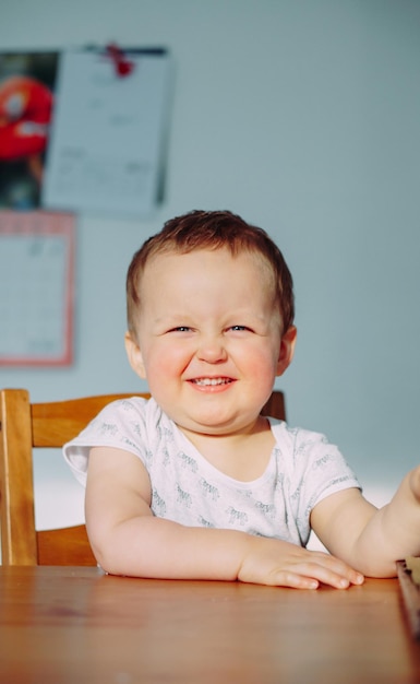 portrait of cute boy sitting on table