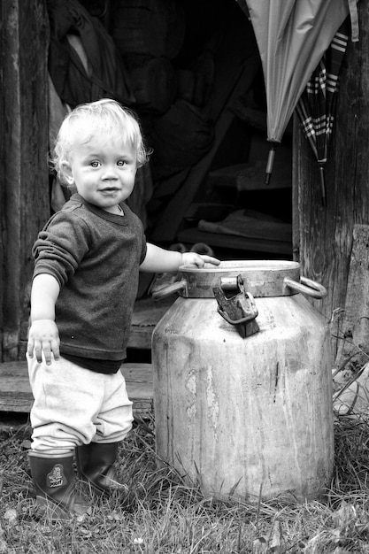 Portrait of cute boy sitting on wood